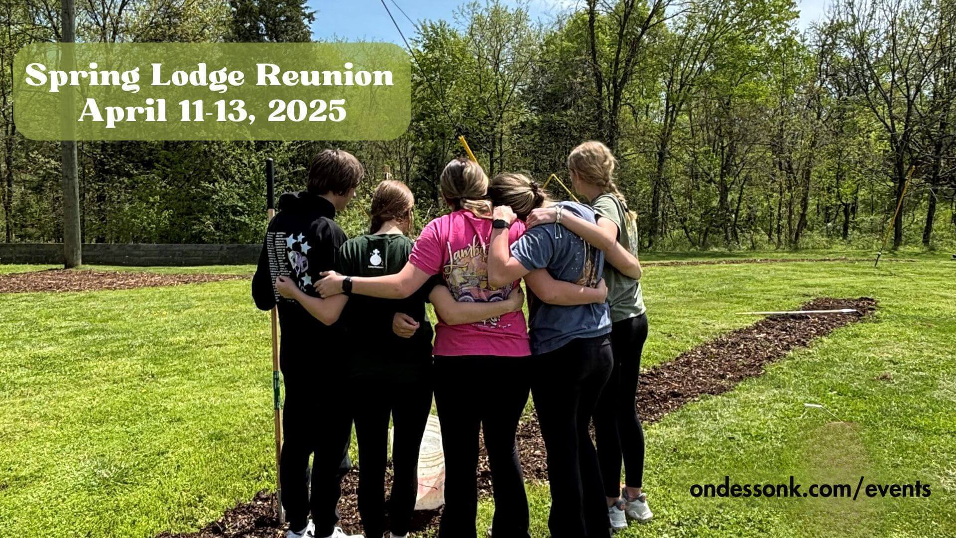 Group of friends hugging at Spring Lodge reunion.