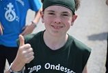 Smiling teen giving thumbs up at camp
