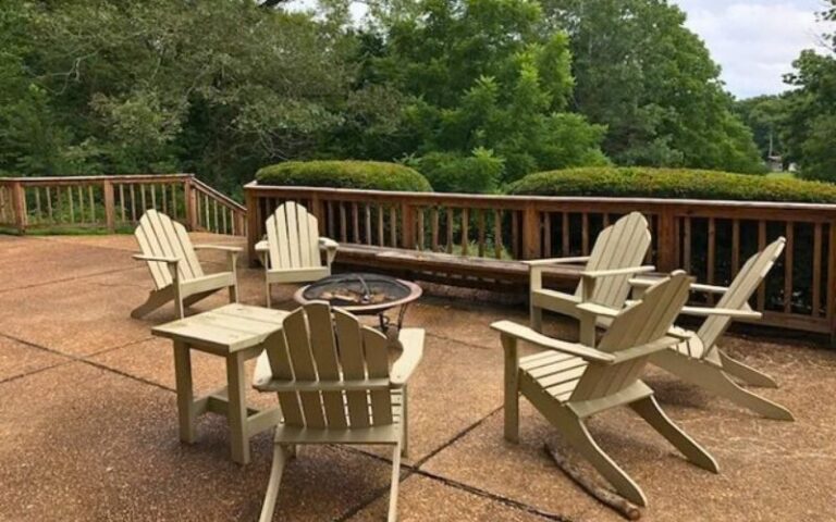 Adirondack chairs around fire pit on deck