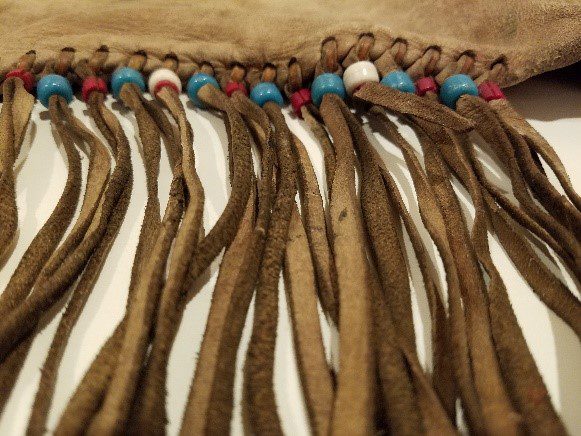 Brown leather fringe with beads.