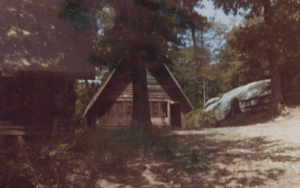 A frame A-cabin in the woods.