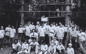 Campers in striped shirts at summer camp.