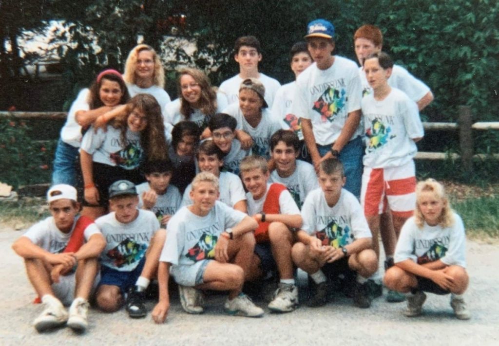 Group of kids wearing camp shirts.