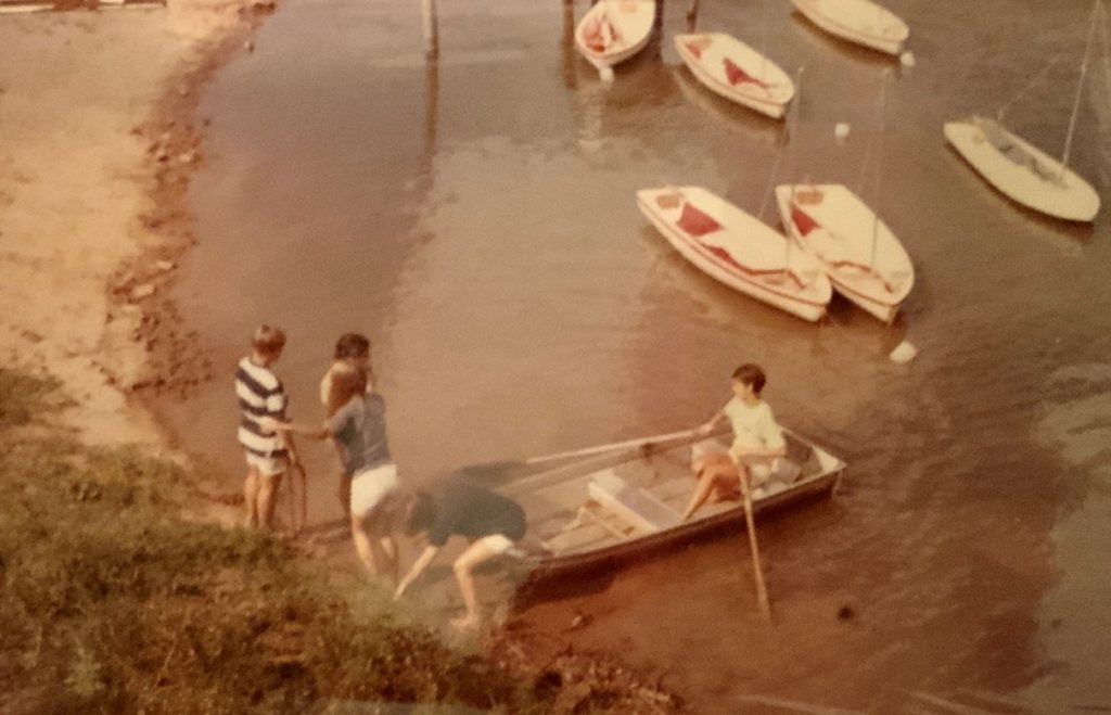 Sailing at Camp Ondessonk Boys in a row boat.