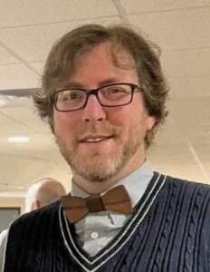 Man wearing glasses and a bow tie.