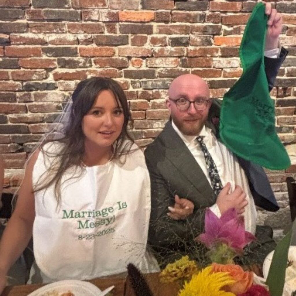 Couple celebrating marriage with playful bibs.