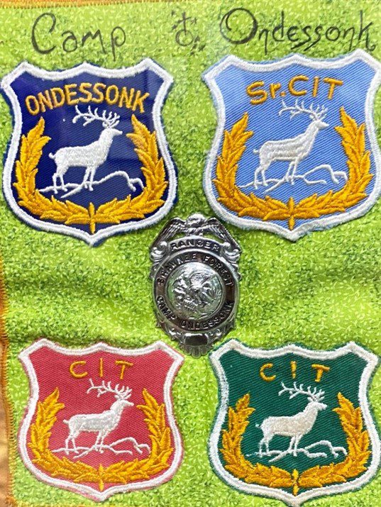Camp Ondessonk CIT badges with deer.