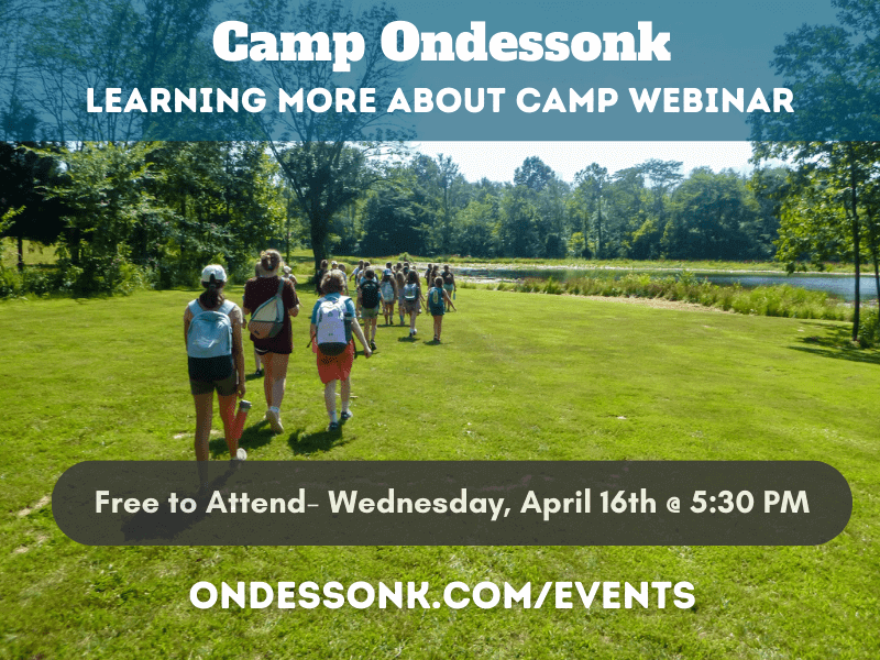 Camp group walking toward lakeshore through grass