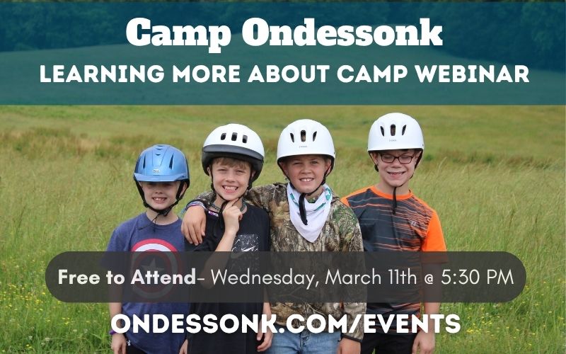 Four smiling children wearing helmets at Camp Ondessonk