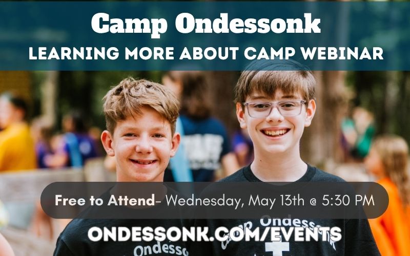 Two smiling boys at camp event.