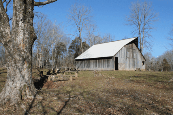 A charming wooden barn in a secluded wooded area, perfect for event and meeting spaces.