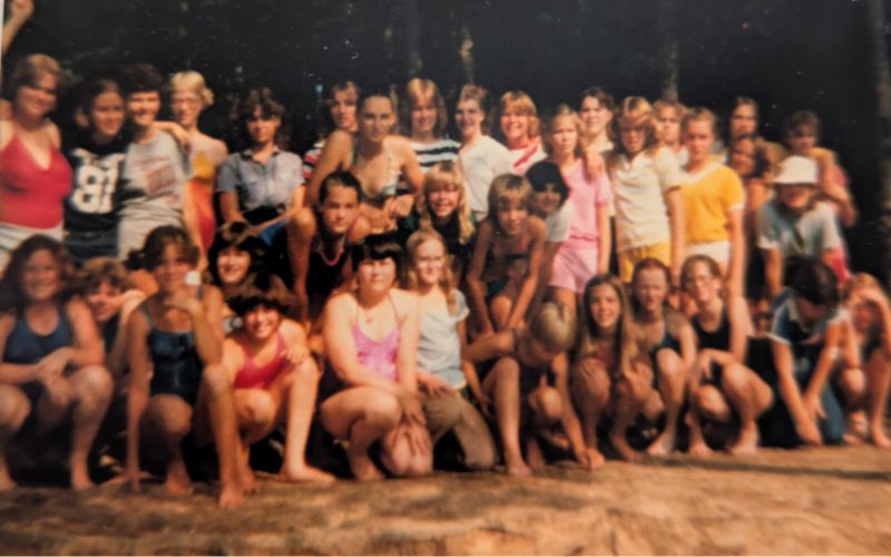 Group of people posing outdoors together.