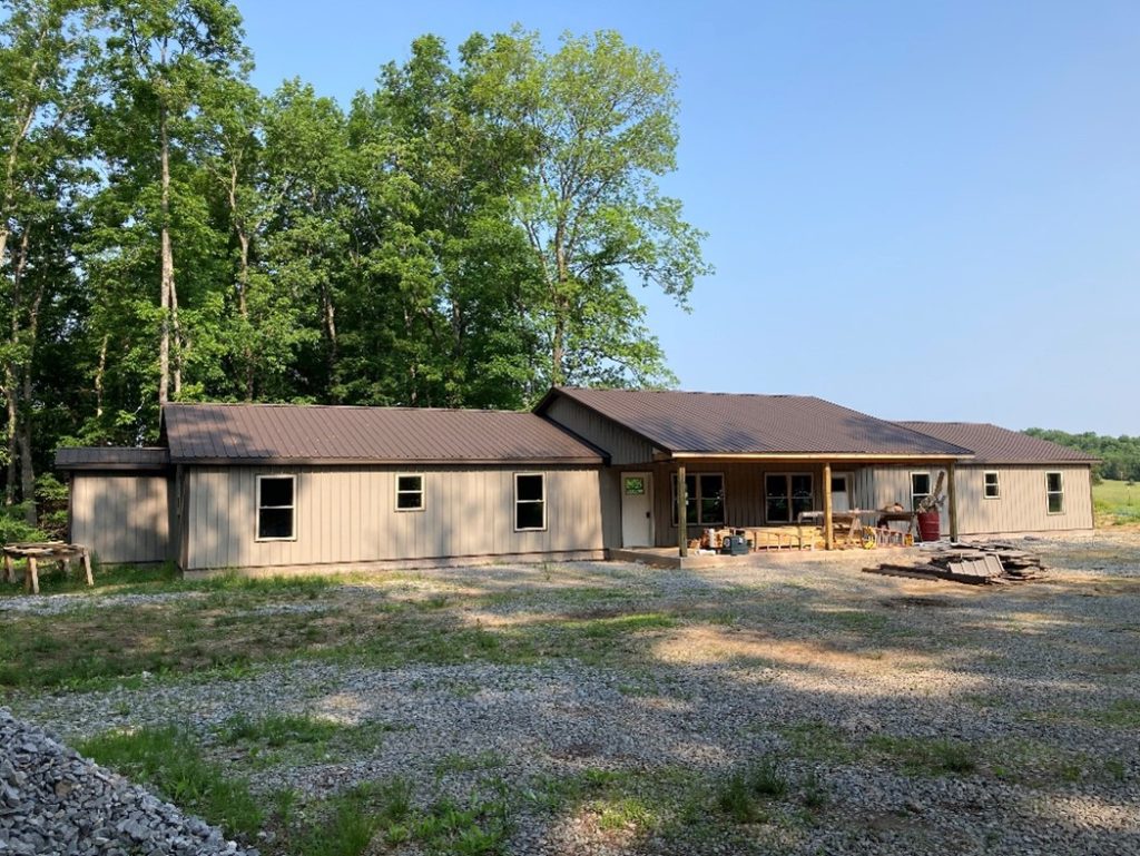 A gray house with a brown roof.