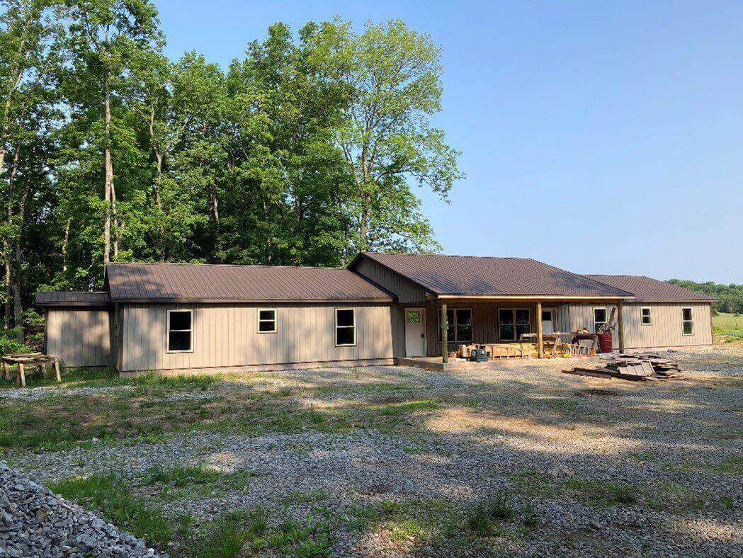 A gray house with a brown roof.