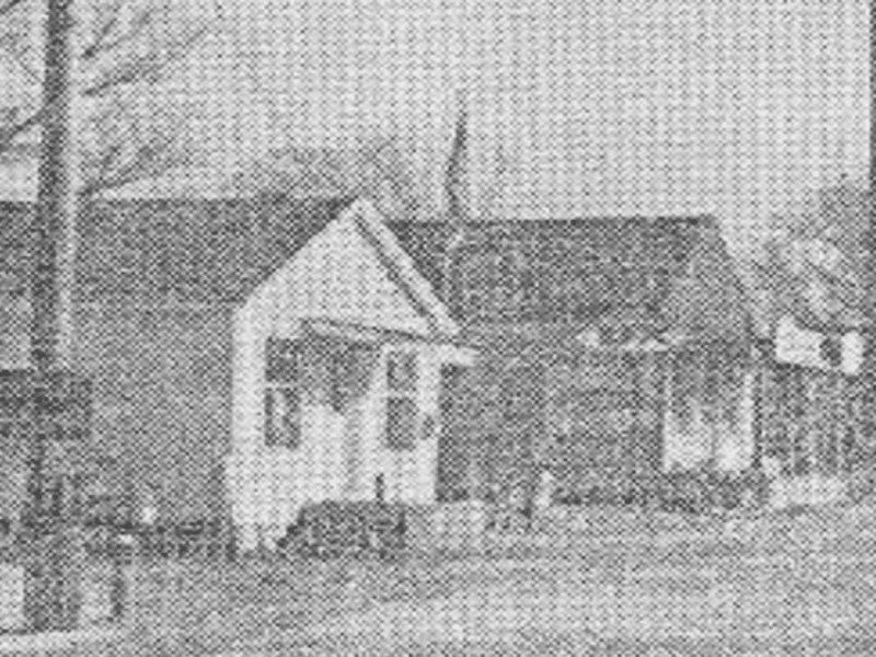 Black and white photo of two houses.