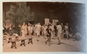 Group of people outdoors near trees.