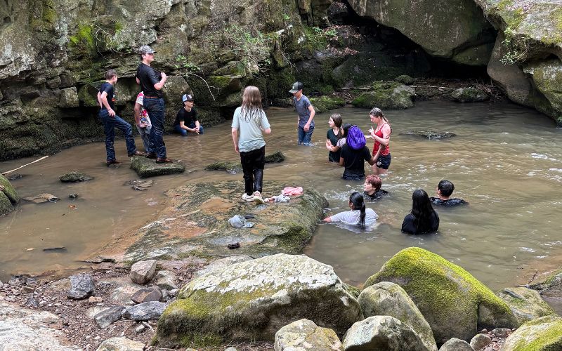 Holland Construction Outdoor Education Scholarship Shares Ondessonk with Collinsville Middle School. Students playing in a creek at Camp Ondessonk.