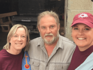 Three people smiling for a photo.