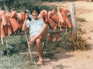 Woman sitting on a bench with life jackets.