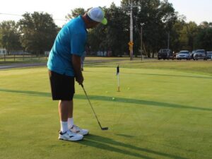 Driving Change: 29th Annual Pete Korte Memorial Golf Benefit for Camp Ondessonk Golfer putting in the Camp Ondessonk Golf Benefit