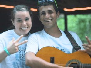 Man playing guitar with a woman