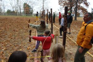 Girls practice archery at a camp.