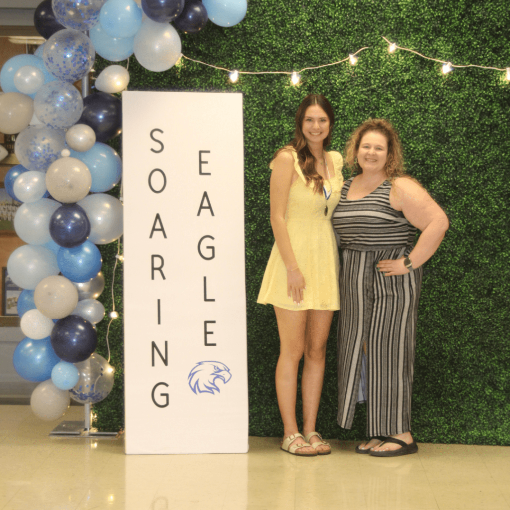 Two women smiling at Soaring Eagle event.