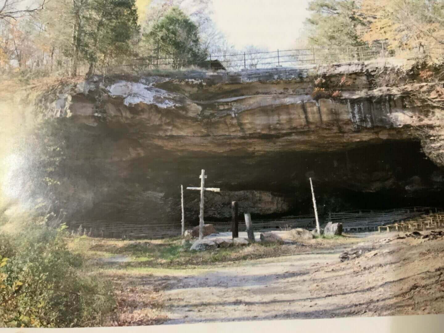 A picture of a cave with a cross, depicting the rich history of a missionary endeavor.