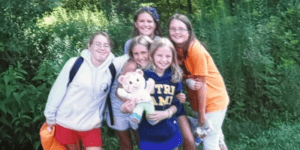 Group of girls at summer camp with stuffed animal.