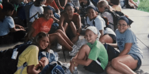 Group of girls sitting outdoors, summer camp.