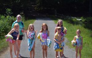 Kids and adult with towels after swimming.