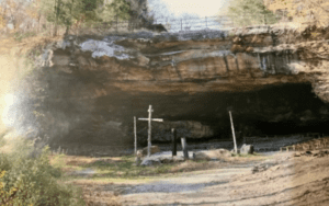 Cave shrine with crosses at entrance.