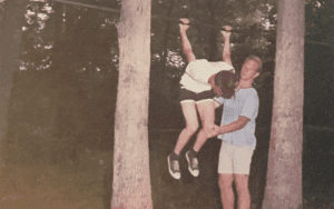 Two kids playing on a jungle gym.