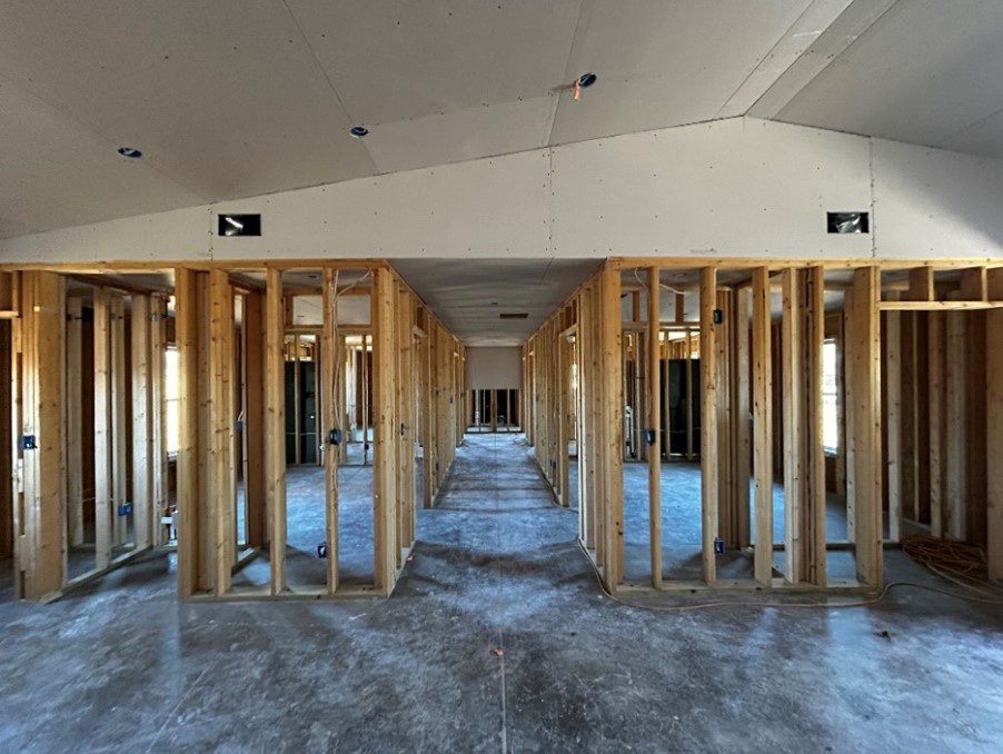 Empty room with unfinished walls and ceiling.