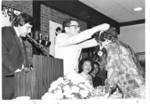 Award ceremony: man presenting medal to woman.