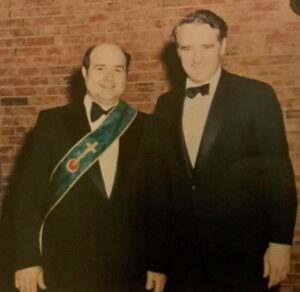 Two men in formal wear at an event.