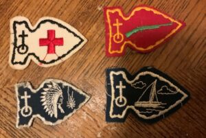 Four embroidered arrowhead patches.