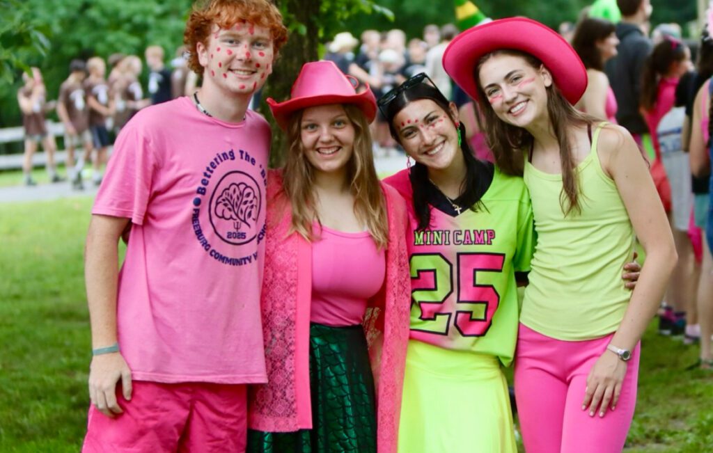 Smiling campers in neon pink and green
