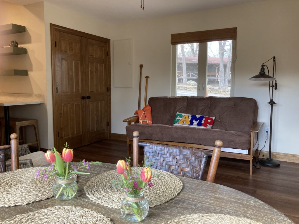 A living room with a table and chairs.