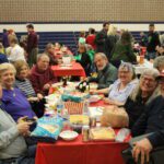 Group of people eating together at a table.