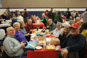 Group of people eating together at a table.