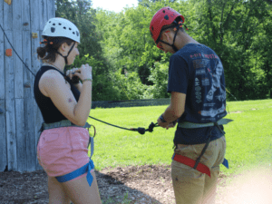 Two people preparing for outdoor climbing.