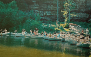 Canoe trip with many people paddling.