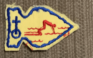 Here's an alt tag for the image: Swimmer merit badge patch.
