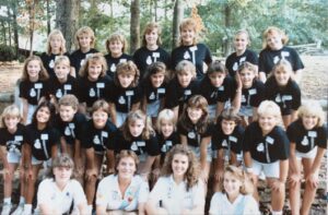 Group of girls wearing black shirts outdoors.