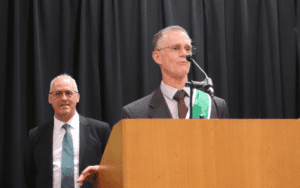 Man giving a speech at podium.