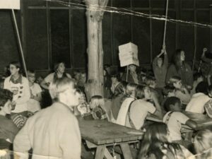 Black and white photo of teenagers at camp.