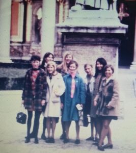 Group of young women standing outside building.