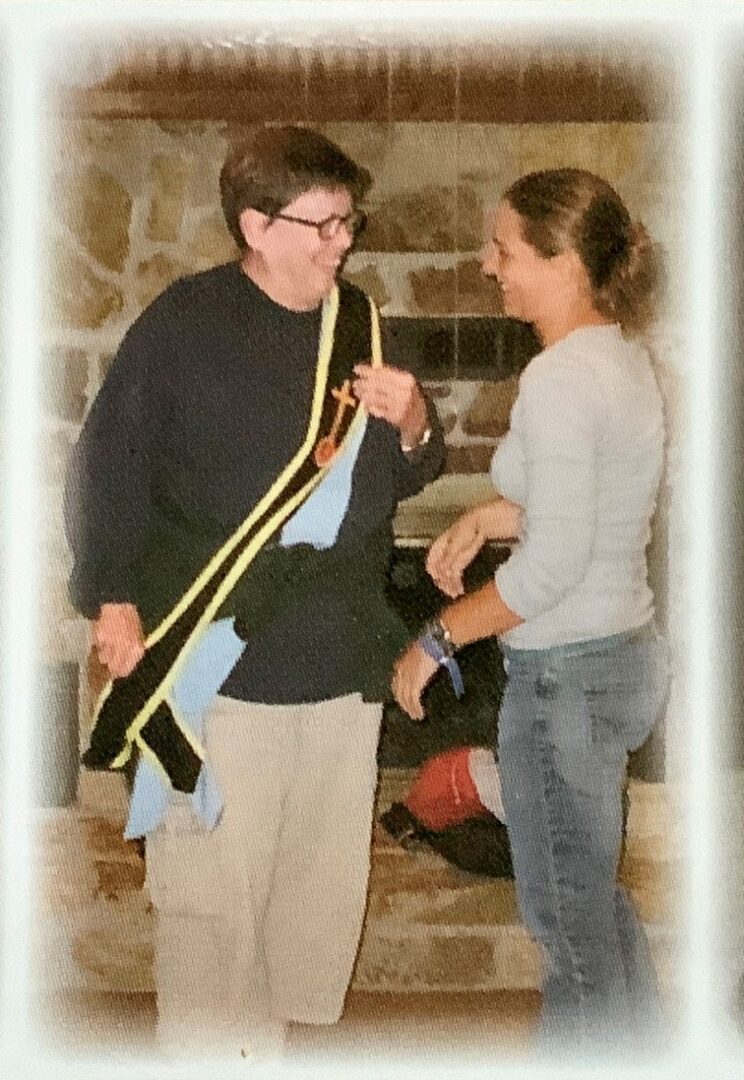 Marci Stephens and another woman standing next to each other in front of a fireplace.
