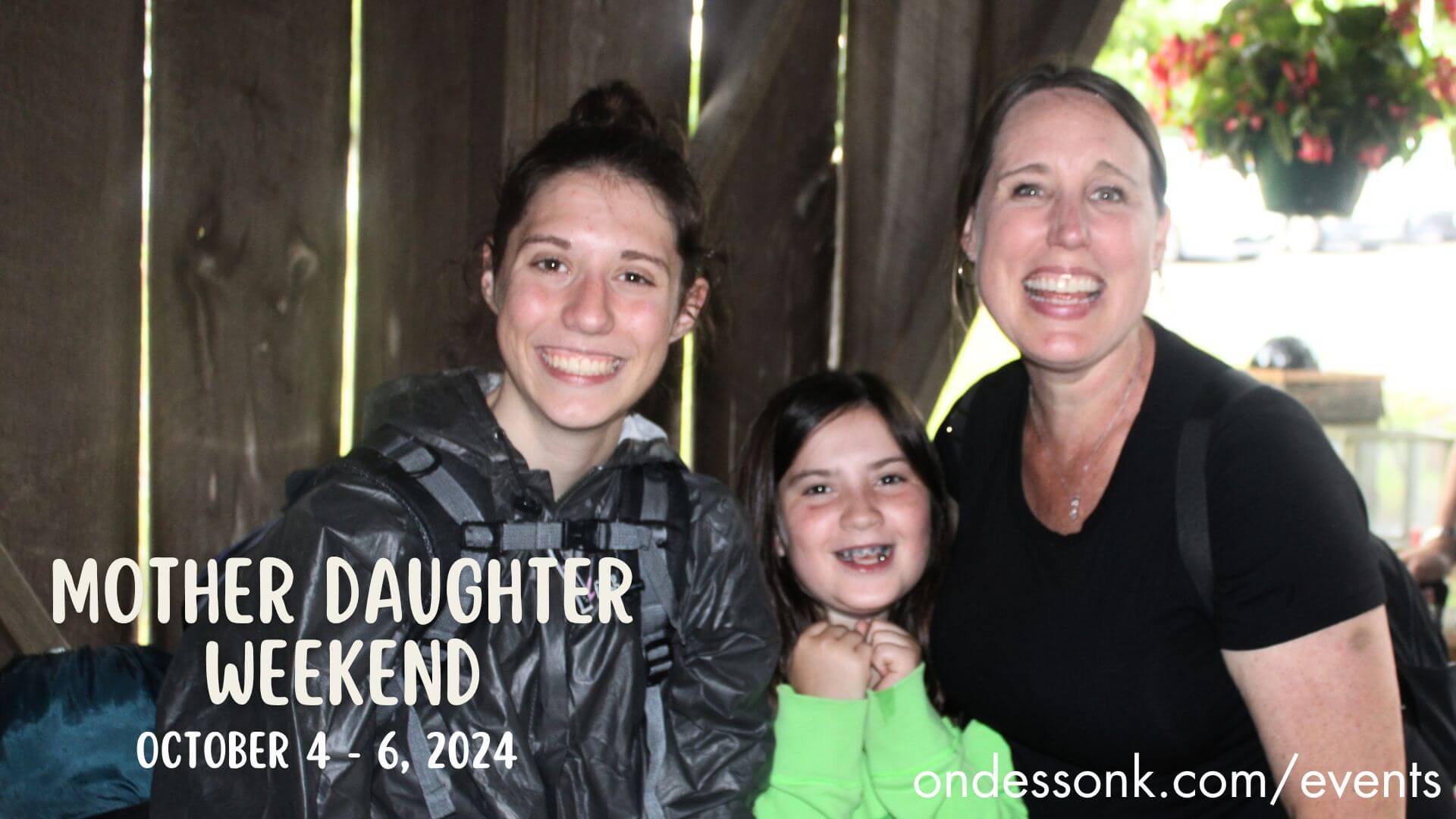 Mother and two daughters smiling at event